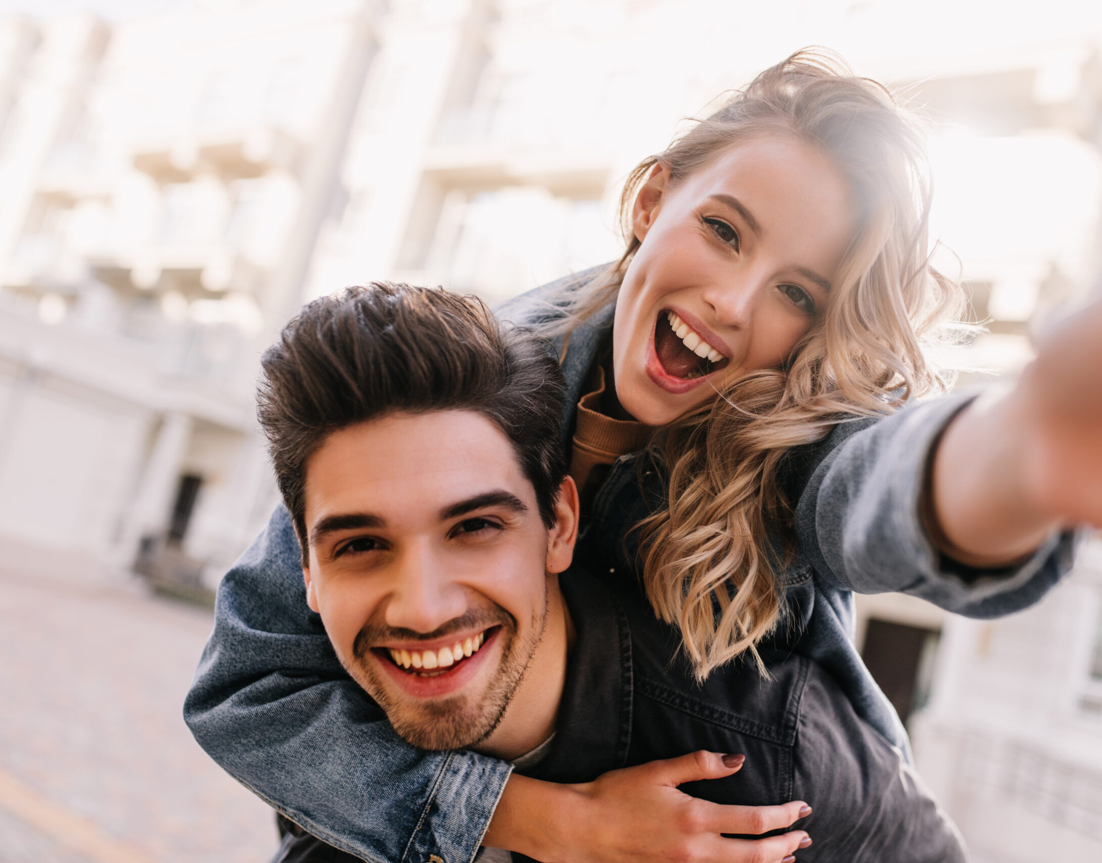 Laughing young couple taking a selfie together